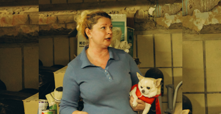 A person holding a small dog
Description automatically generated